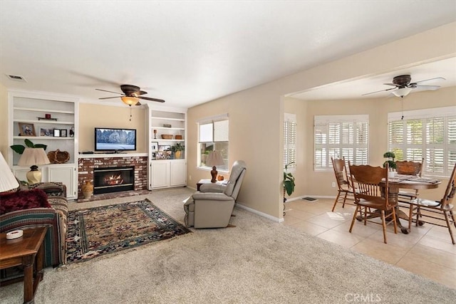 718 Cherry St, Corona, CA 92881 - tiled living area featuring visible vents, built in shelves, baseboards, a brick fireplace, and ceiling fan
