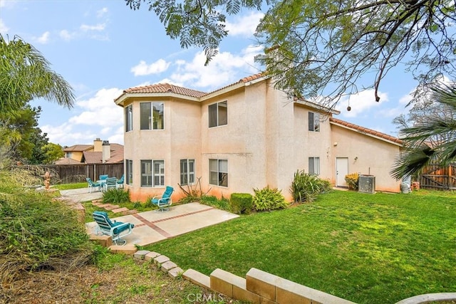 718 Cherry St, Corona, CA 92881 - back of property featuring stucco siding, a patio, fence, and a tile roof
