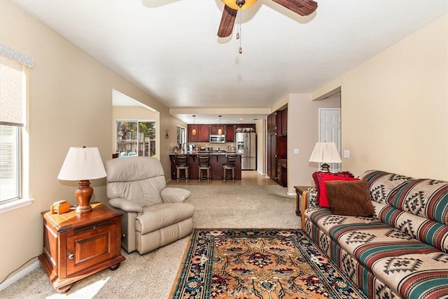 718 Cherry St, Corona, CA 92881 - living room featuring baseboards, light carpet, and a ceiling fan