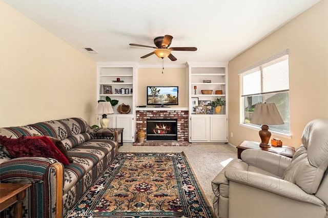 718 Cherry St, Corona, CA 92881 - carpeted living room with a brick fireplace, built in features, a ceiling fan, and visible vents