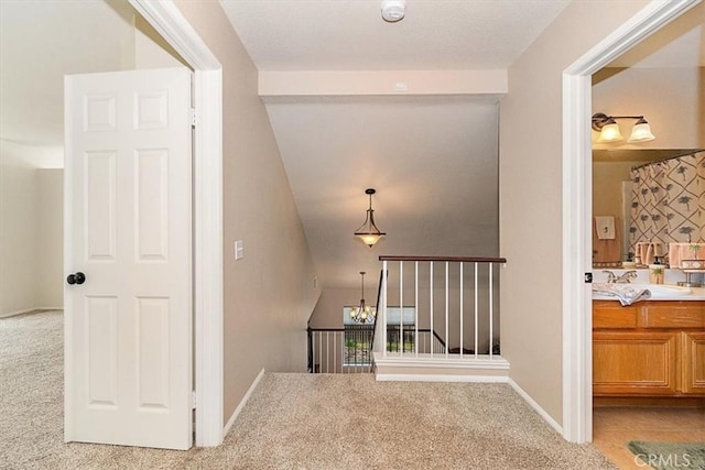 718 Cherry St, Corona, CA 92881 - corridor featuring light carpet, a chandelier, and baseboards