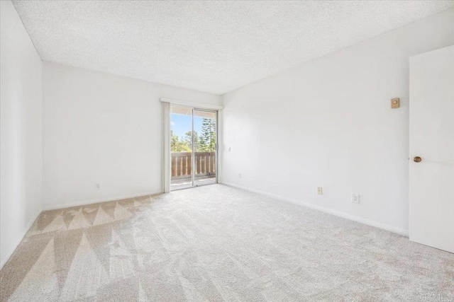 5700 Baltimore Dr Unit 232, La Mesa, CA 91942 - empty room featuring a textured ceiling, carpet, and baseboards