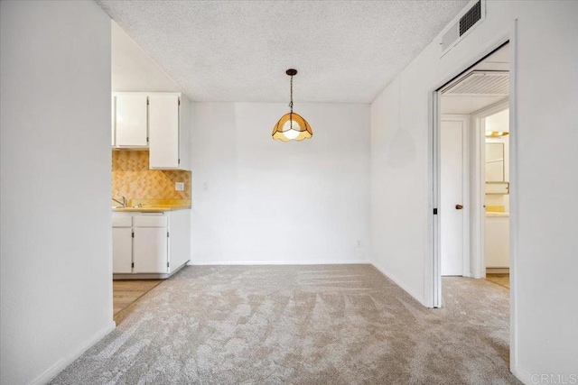 5700 Baltimore Dr Unit 232, La Mesa, CA 91942 - unfurnished dining area featuring light carpet, a textured ceiling, baseboards, and visible vents