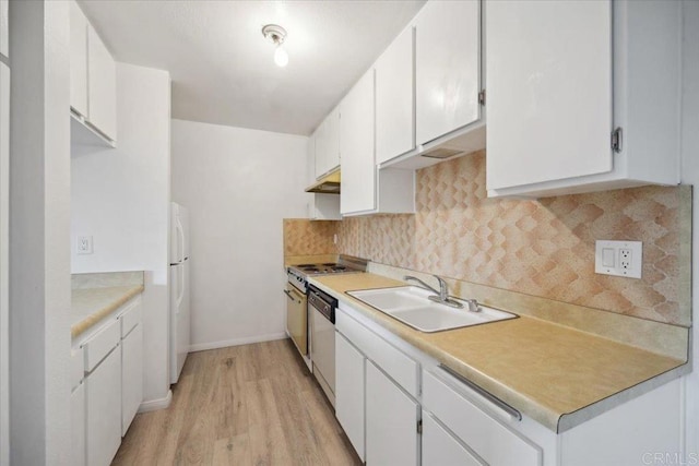 5700 Baltimore Dr Unit 232, La Mesa, CA 91942 - kitchen featuring a sink, freestanding refrigerator, light wood-style flooring, white cabinetry, and light countertops