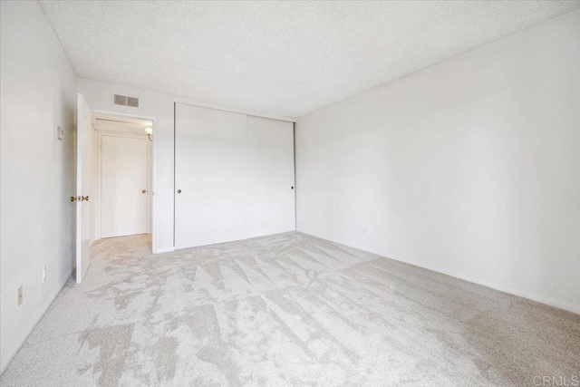 5700 Baltimore Dr Unit 232, La Mesa, CA 91942 - unfurnished room featuring carpet flooring, a textured ceiling, and visible vents