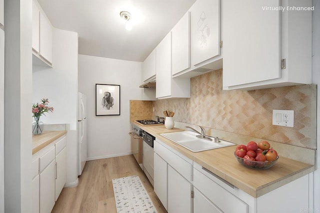 5700 Baltimore Dr Unit 232, La Mesa, CA 91942 - kitchen featuring freestanding refrigerator, under cabinet range hood, stainless steel gas stovetop, a sink, and light countertops