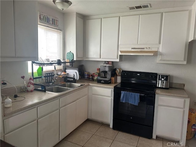 kitchen with light countertops, black range with electric stovetop, visible vents, and under cabinet range hood
