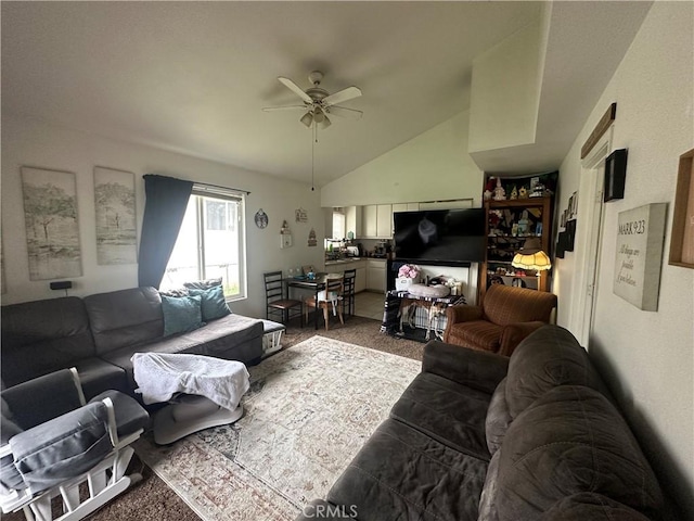 carpeted living area with a ceiling fan and vaulted ceiling