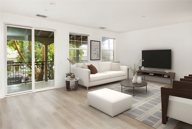 living room featuring visible vents and wood finished floors