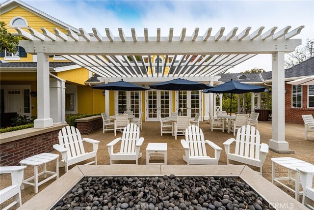 view of patio / terrace featuring french doors, a pergola, and outdoor dining area