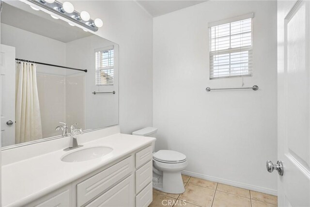 bathroom featuring baseboards, a shower with curtain, toilet, vanity, and tile patterned flooring