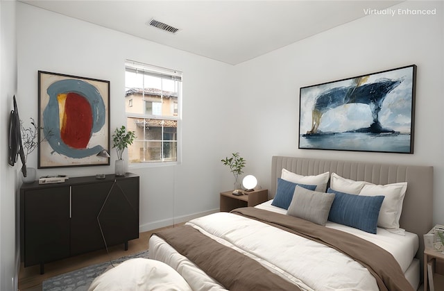 bedroom featuring visible vents and baseboards
