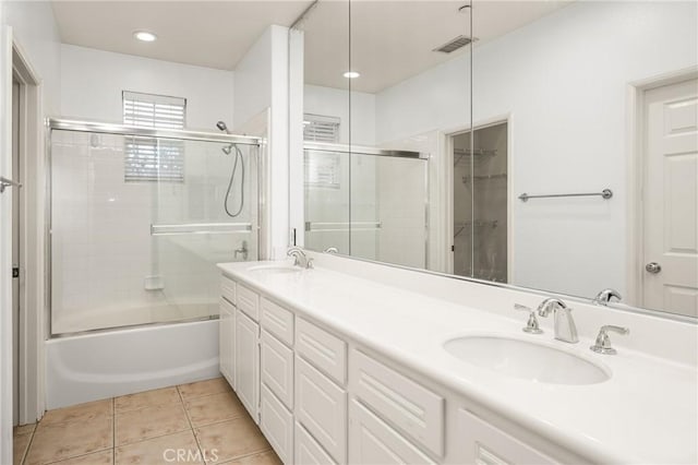 full bath with double vanity, a sink, tile patterned flooring, and visible vents