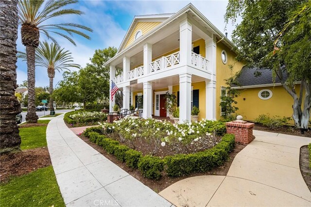24 Dietes Ct, Ladera Ranch, CA 92694 - view of side of property featuring a balcony, covered porch, and stucco siding