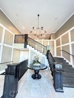 838 Pine Ave Unit 510, Long Beach, CA 90813 - stairs with a chandelier and crown molding