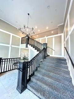 838 Pine Ave Unit 510, Long Beach, CA 90813 - stairs featuring a chandelier and recessed lighting