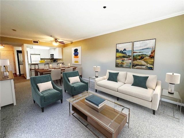 838 Pine Ave Unit 510, Long Beach, CA 90813 - living room with crown molding, ceiling fan, baseboards, and light colored carpet