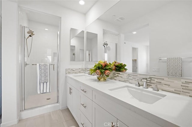 148 Modjeska, Irvine, CA 92618 - bathroom featuring a shower stall, double vanity, backsplash, and recessed lighting