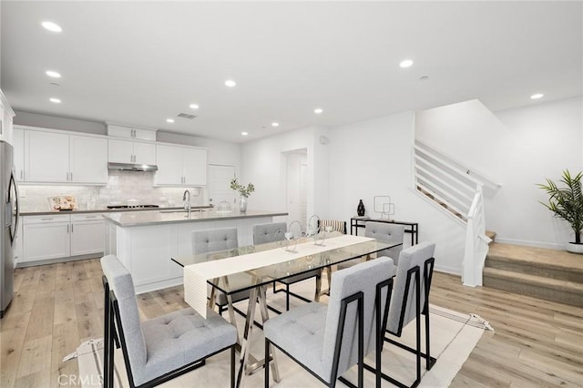 148 Modjeska, Irvine, CA 92618 - dining area featuring light wood-style flooring, recessed lighting, and stairs