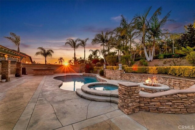 view of pool with an outdoor fire pit, an in ground hot tub, and a patio area