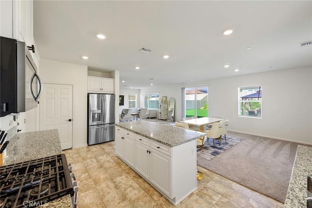 19568 Sunkissed Ridge Dr, Riverside, CA 92507 - kitchen featuring stainless steel appliances, white cabinetry, recessed lighting, a kitchen island, and open floor plan