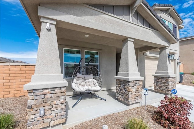 19568 Sunkissed Ridge Dr, Riverside, CA 92507 - view of exterior entry with board and batten siding, stucco siding, fence, and stone siding