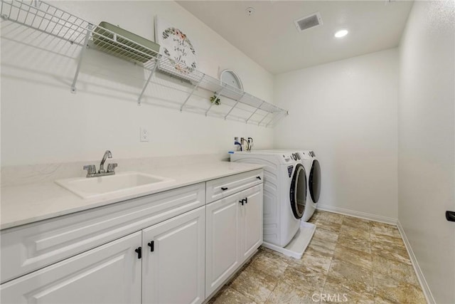 19568 Sunkissed Ridge Dr, Riverside, CA 92507 - clothes washing area with cabinet space, baseboards, washing machine and clothes dryer, light stone finish flooring, and recessed lighting