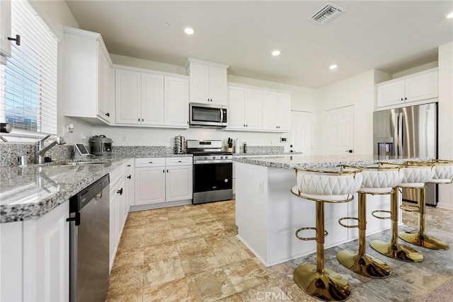 19568 Sunkissed Ridge Dr, Riverside, CA 92507 - kitchen featuring stainless steel appliances, a sink, white cabinetry, and recessed lighting