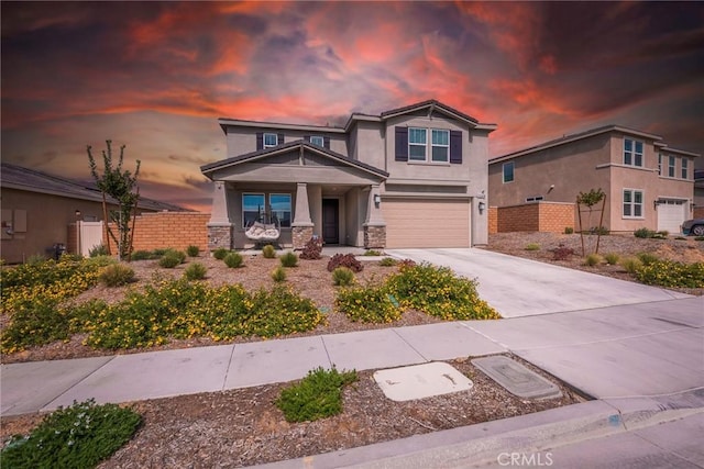 19568 Sunkissed Ridge Dr, Riverside, CA 92507 - craftsman-style house with stucco siding, a porch, driveway, a garage, and stone siding