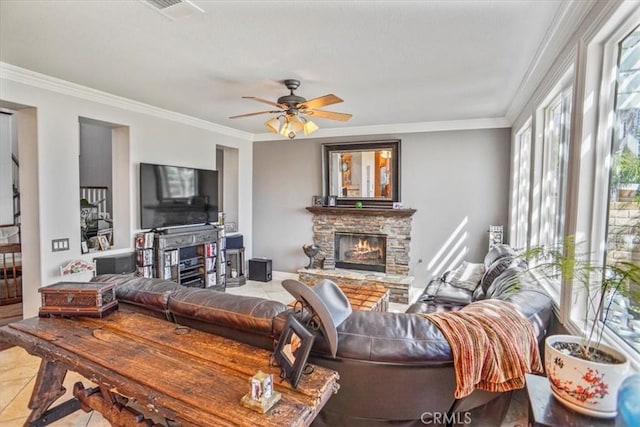 29086 Madrid Pl, Castaic, CA 91384 - tiled living room with a stone fireplace, ornamental molding, ceiling fan, and visible vents