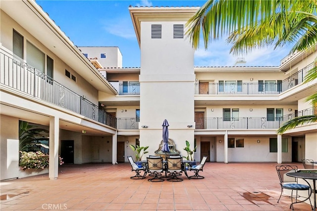 surrounding community with outdoor dining space and a patio area