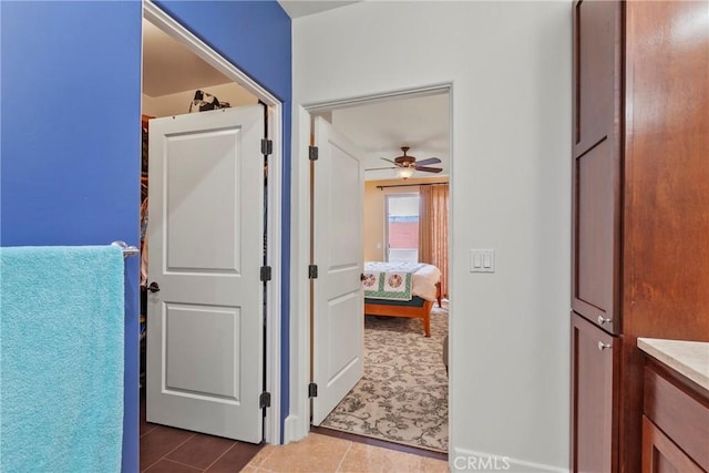 hall featuring dark tile patterned flooring
