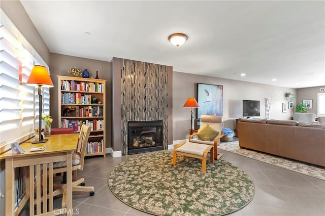 living area with tile patterned floors, recessed lighting, and a large fireplace