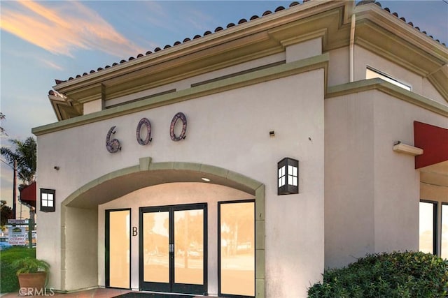 entrance to property featuring stucco siding