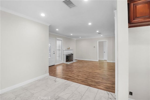 unfurnished living room with recessed lighting, a fireplace with raised hearth, visible vents, and crown molding