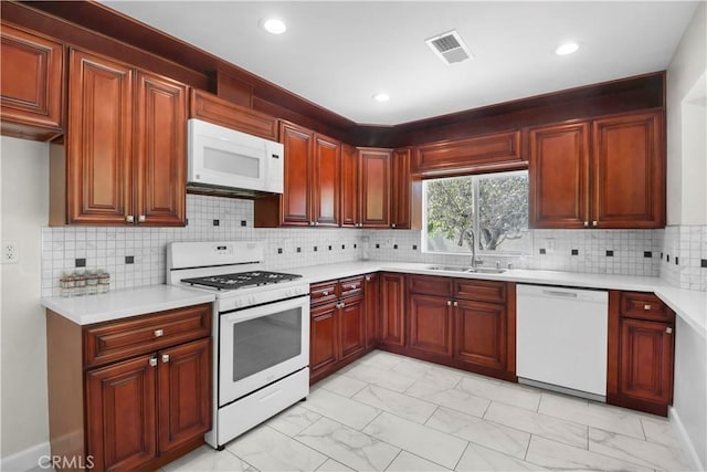 kitchen featuring marble finish floor, a sink, white appliances, and visible vents