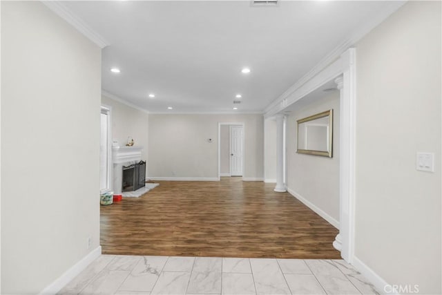 unfurnished living room featuring baseboards, a fireplace with raised hearth, crown molding, recessed lighting, and marble finish floor