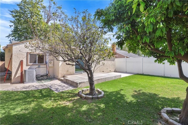 view of yard featuring central AC, a fenced backyard, and a patio