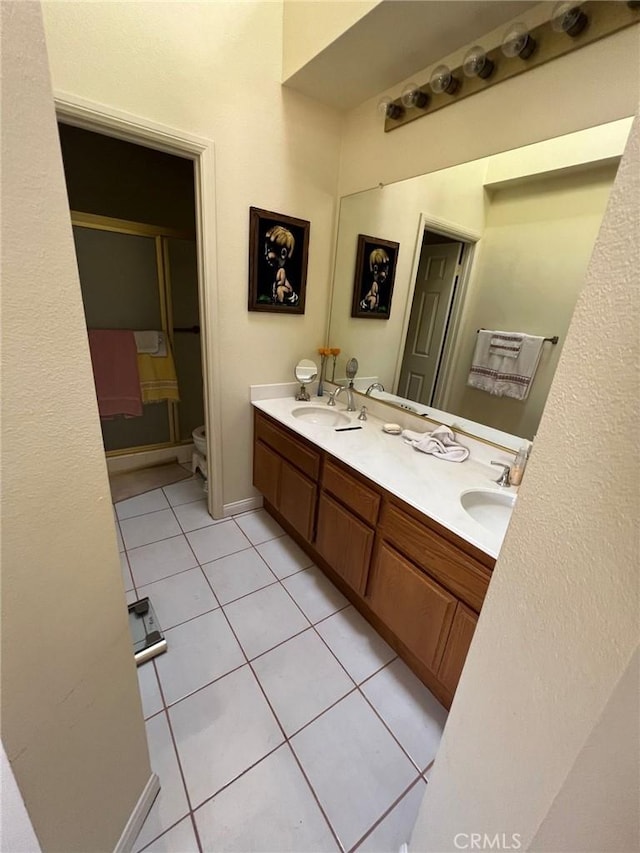 18269 Sanmian Ct, Fountain Valley, CA 92708 - full bathroom with tile patterned floors, double vanity, and toilet