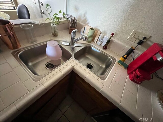 18269 Sanmian Ct, Fountain Valley, CA 92708 - kitchen view of tile counters and a textured wall