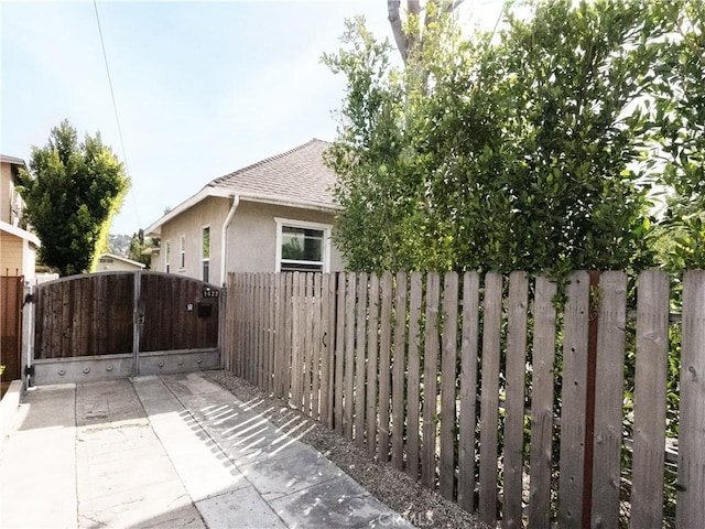 exterior space featuring fence and a gate