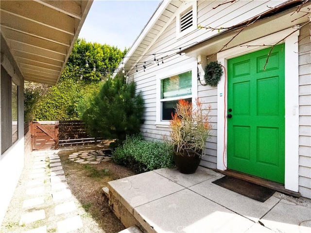 view of exterior entry with fence