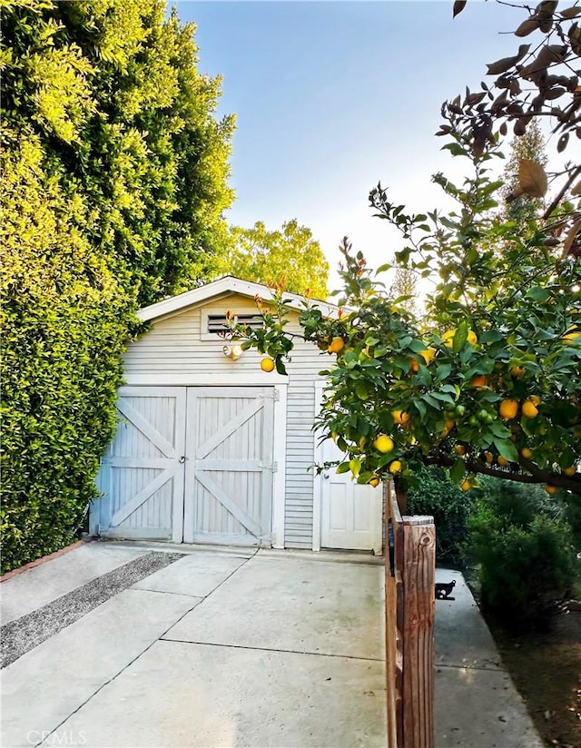 garage featuring a storage shed