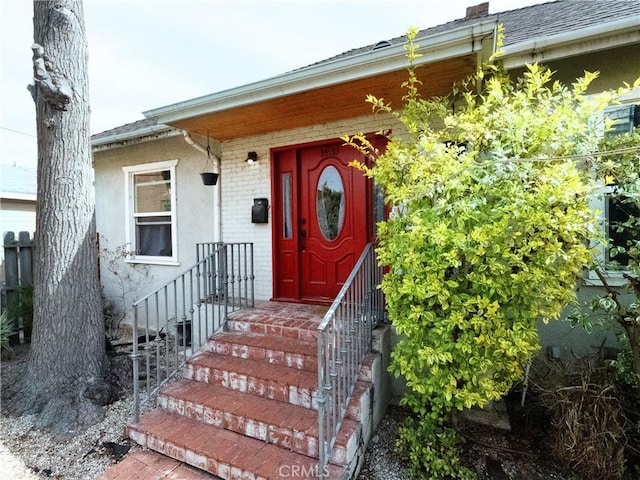 doorway to property featuring brick siding