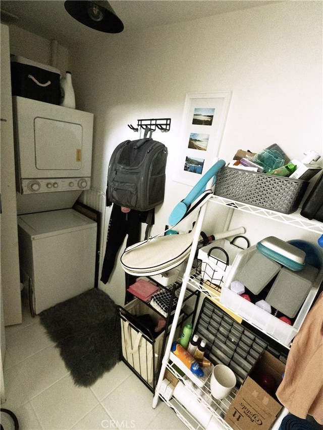 washroom with tile patterned floors, laundry area, and stacked washer / dryer