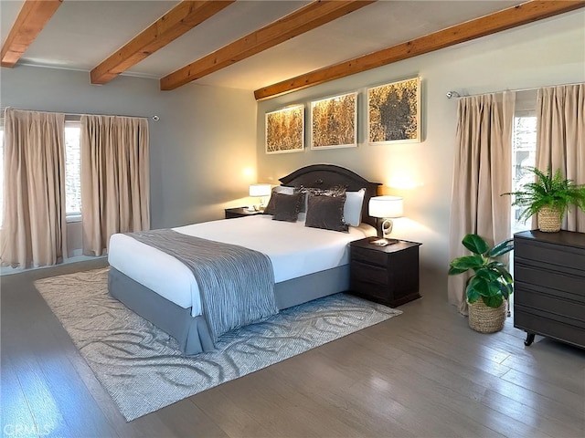 bedroom featuring beamed ceiling and hardwood / wood-style floors