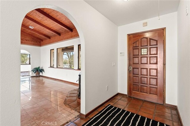 13155 San Antonio Rd, Atascadero, CA 93422 - foyer featuring lofted ceiling with beams, wood ceiling, arched walkways, and baseboards
