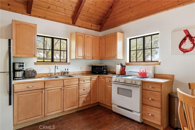 13155 San Antonio Rd, Atascadero, CA 93422 - kitchen featuring white range with gas cooktop, a sink, freestanding refrigerator, black microwave, and vaulted ceiling with beams