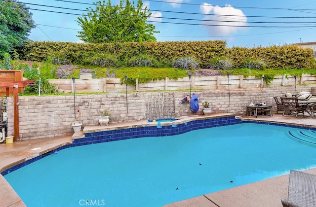 view of swimming pool with a fenced in pool, an in ground hot tub, a fenced backyard, and a patio