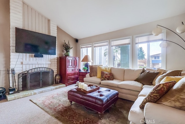 living room with plenty of natural light, a brick fireplace, carpet floors, and vaulted ceiling